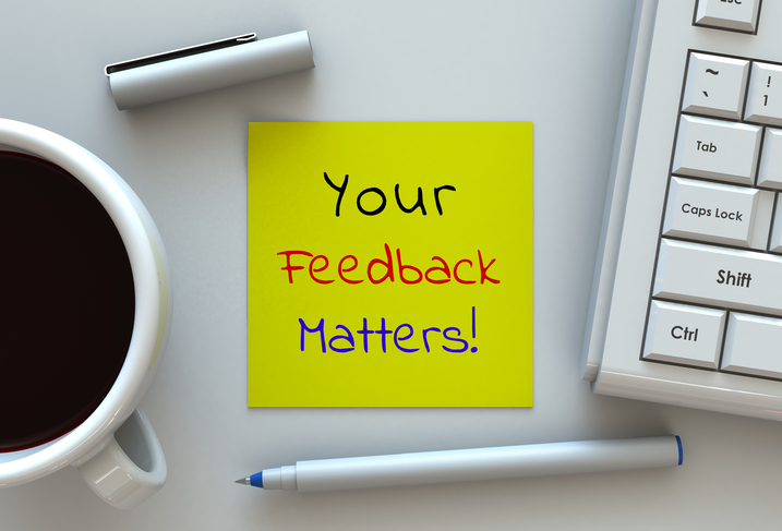 Your Feedback Matters, message on note paper, computer and coffee on table